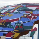 people-stand-beside-a-sculpture-of-the-african-continent-painted-with-the-flags-of-african-nations-at-the-place-du-souvenir-africain-in-dakar-senegal-september-3-2026.-reuters